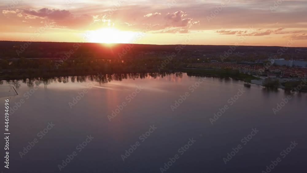 Beautiful sunset with clouds over the river under construction houses in the dark, Ukraine, Kiev on May 6. Beautiful sunset with clouds over the river under construction houses in the dark, Ukraine, Kiev on May 6.