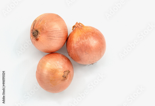 Top view small group of onion, three onions on white background with skin.
