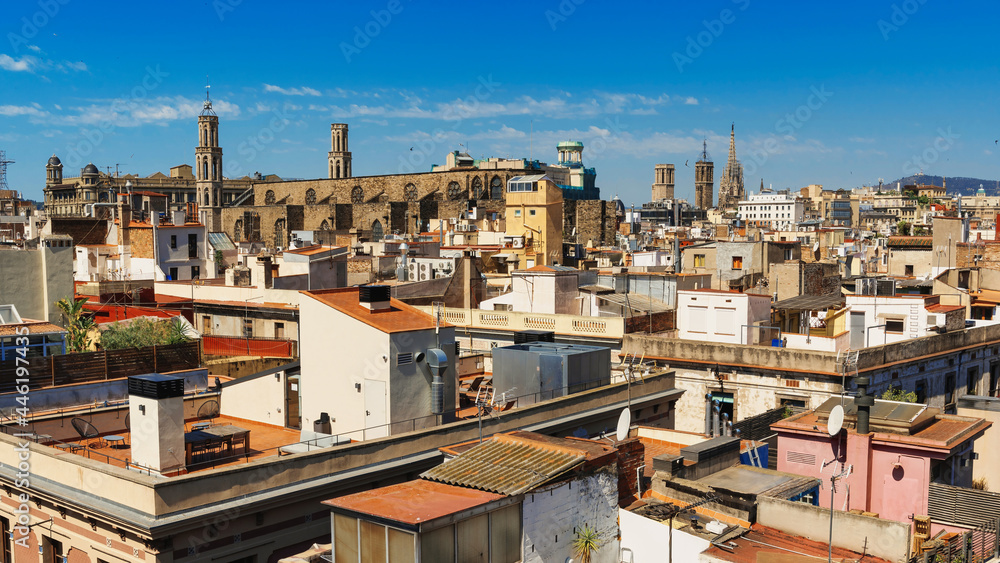 Panoramic view of Barcelona, multiple building's roofs, old cathedrals