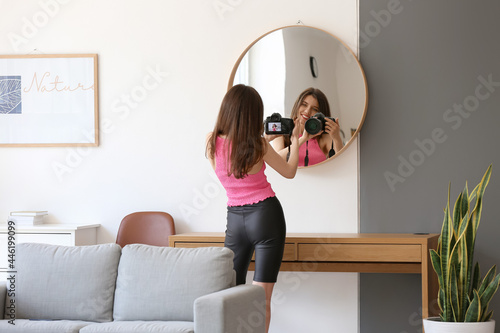 Beautiful young woman takin...