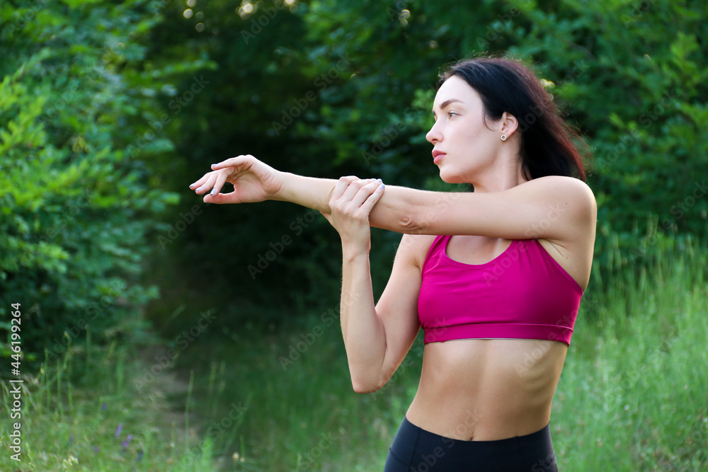 Young healthy beautiful woman in sports top and leggings, doing sport exercises on the street, sport and life style concept Young healthy beautiful woman in sports top and leggings, doing sport exercises on the street, sport and life style concept