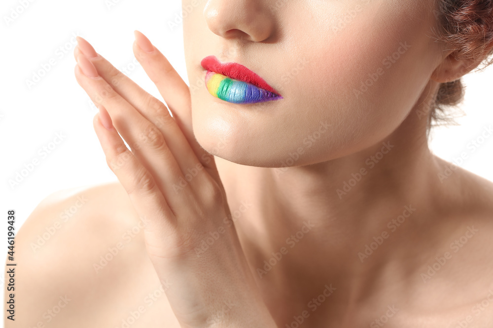 Obraz premium Beautiful young woman with rainbow lips on white background, closeup