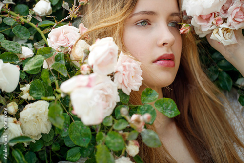 Beautiful young woman smells a rose flower. High quality photo