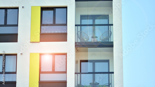  Modern apartment buildings on a sunny day with a blue sky. Facade of a modern apartment building. Glass surface with sunlight.