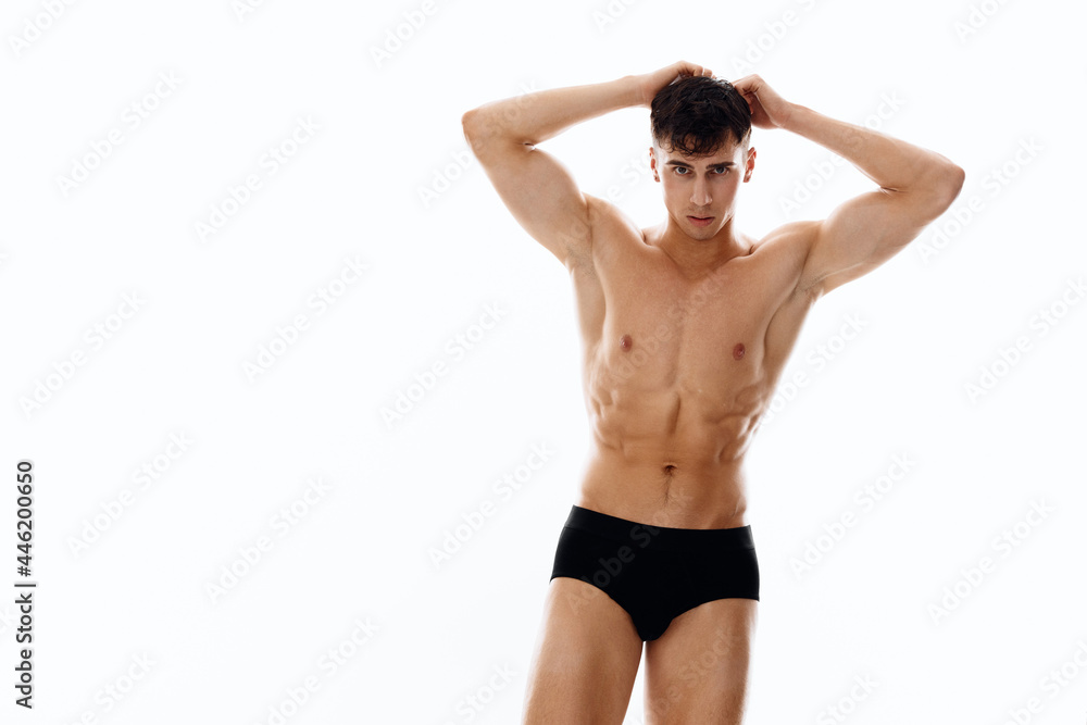 brunette man in panties and naked torso holds hands near face brunette man in panties and naked torso holds hands near face