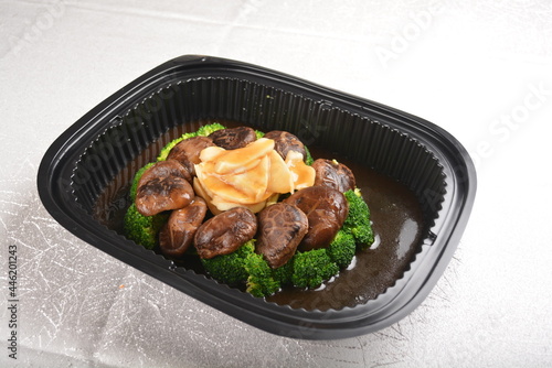 stir fried broccoli vegetable with abalone and mushroom in oyster sauce in black bento party box for asian take away halal menu