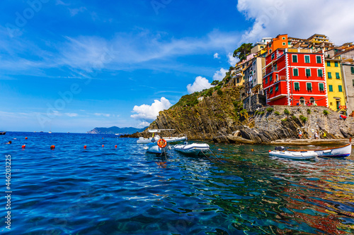 CINQUE TERRE, ITALY - July 18, 2019: Classic View of Manarola - Colorful Houses in a Dramatic Cliff Rock Formation near the Sea with a Fishing Natural Harbor