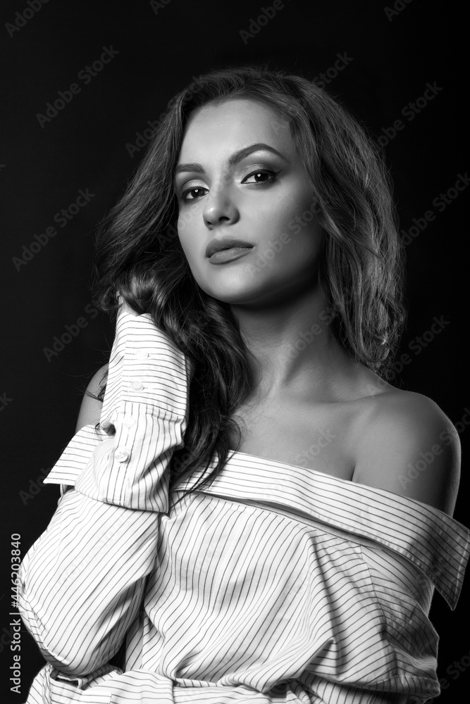 Attractive young lady posing in shirt at studio