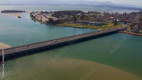 Aerial View Of Cars Driving At Windang Road Bridge And Windang Suburb near Wollongong In NSW, Australia photo