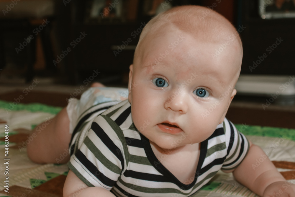 Beautiful little caucasian baby boy lying on lounge room floor Beautiful little caucasian baby boy lying on lounge room floor