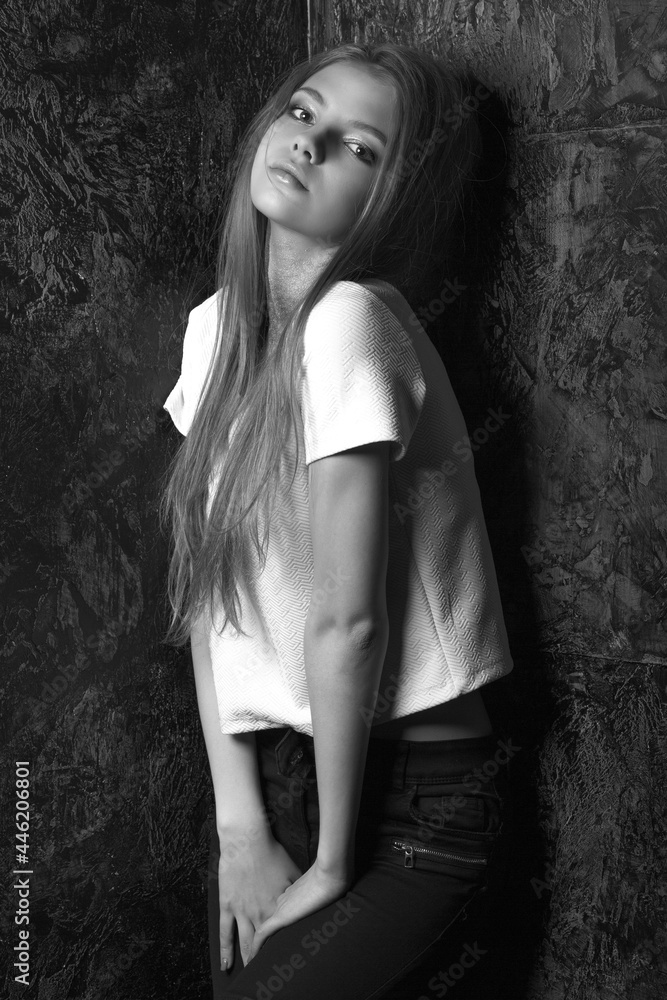 Stylish dressed magnificent woman posing in a dark room Stylish dressed magnificent woman posing in a dark room