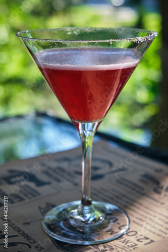 A cosmopolitan cocktail in a restaurant, on a table standing on the veranda.