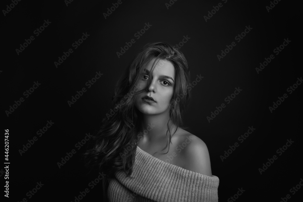 Naklejka premium Adorable young woman with long curly hair with bare shoulders