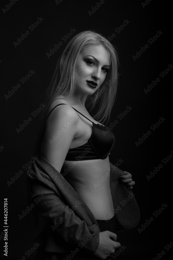 Luxurious model wears bra and jacket posing at studio Luxurious model wears bra and jacket posing at studio
