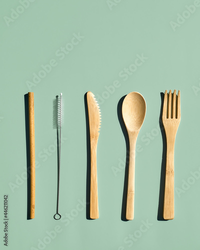 Eco friendly bamboo cutlery set on light green pastel background. Zero waste  plastic-free  lifestyle concept.