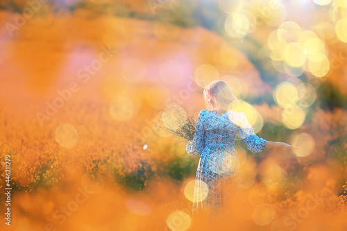 summer girl in a sunny field with flowers, warm happy sunset in nature