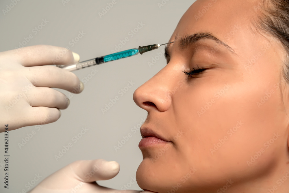 Portrait of a young beautiful woman on a face filler injection procedure