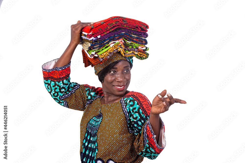 beautiful woman holding traditional loincloths on her head and pointing finger aside smiling.