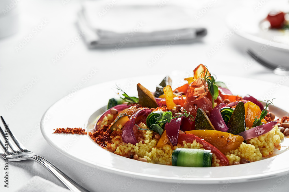 Polenta with stewed vegetables on a light plate, corn grits dish with vegetable stew, traditional Italian cuisine Polenta with stewed vegetables on a light plate, corn grits dish with vegetable stew, traditional Italian cuisine