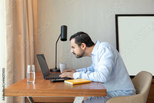 Arab man with poor eyesight looking at this computer photo