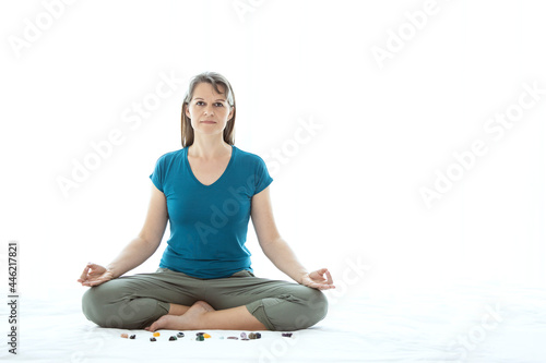 Middle aged woman meditating with crystals