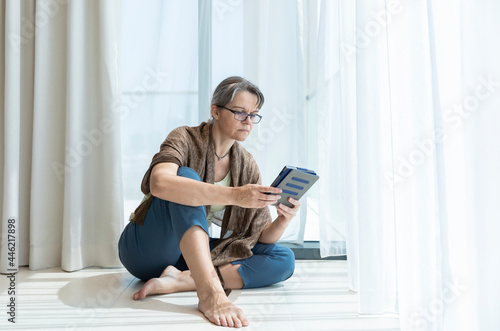 middle aged woman reading a book