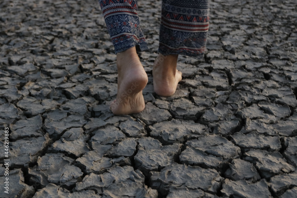 Footsteps on the ground cracked due to drought