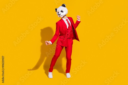 Photo of cheerful carefree panda guy dance wear mask red suit tie footwear isolated on yellow color background photo