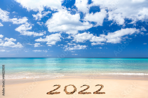 2022 written on sandy beach