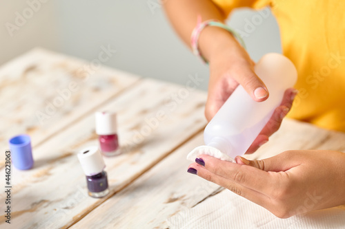 Girl removing nail polish  close up look