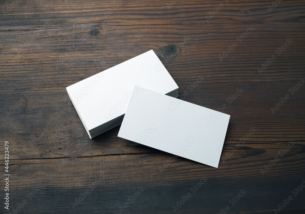 Blank business cards on wood table background. Mockup for branding identity. Template for graphic designers portfolios. Blank business cards on wood table background. Mockup for branding identity. Template for graphic designers portfolios.