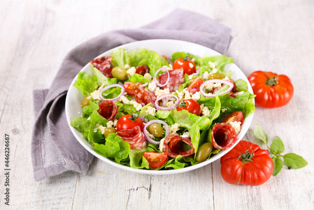 vegetable salad with salami and tomato