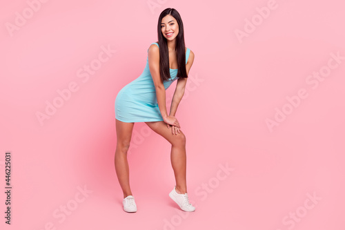 Full size photo of gorgeous brunette hairdo lady stand wear blue dress sneakers isolated on pink color background