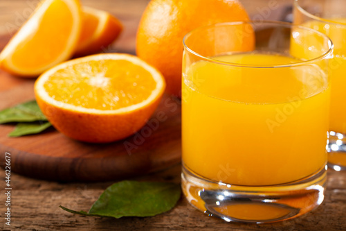 Glass with orange juice on the table.