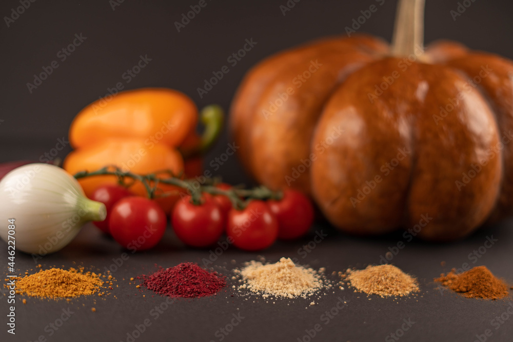 Fresh vegetables and dried veggie powder. Pumpkin, tomato, onion, beet and pepper on dark paper background. Vegetarian healthy detox food. Fresh vegetables and dried veggie powder. Pumpkin, tomato, onion, beet and pepper on dark paper background. Vegetarian healthy detox food.