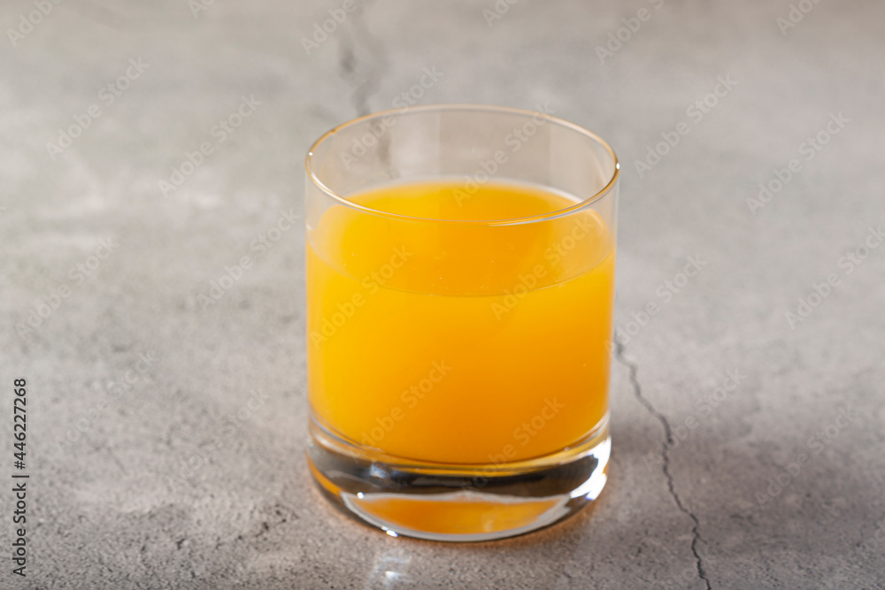 Glass with orange juice on the table. Glass with orange juice on the table.