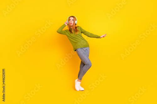 Fototapeta Naklejka Na Ścianę i Meble -  Full length body size photo dancing in earphones girl in casual outfit isolated vibrant yellow color background