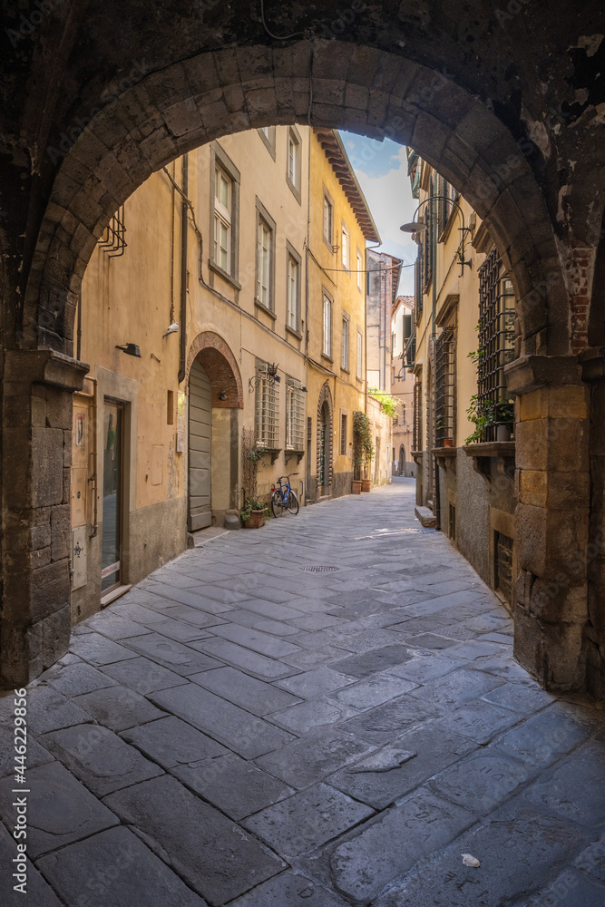 Old empty narrow street of Lucca in Tuscany Italy