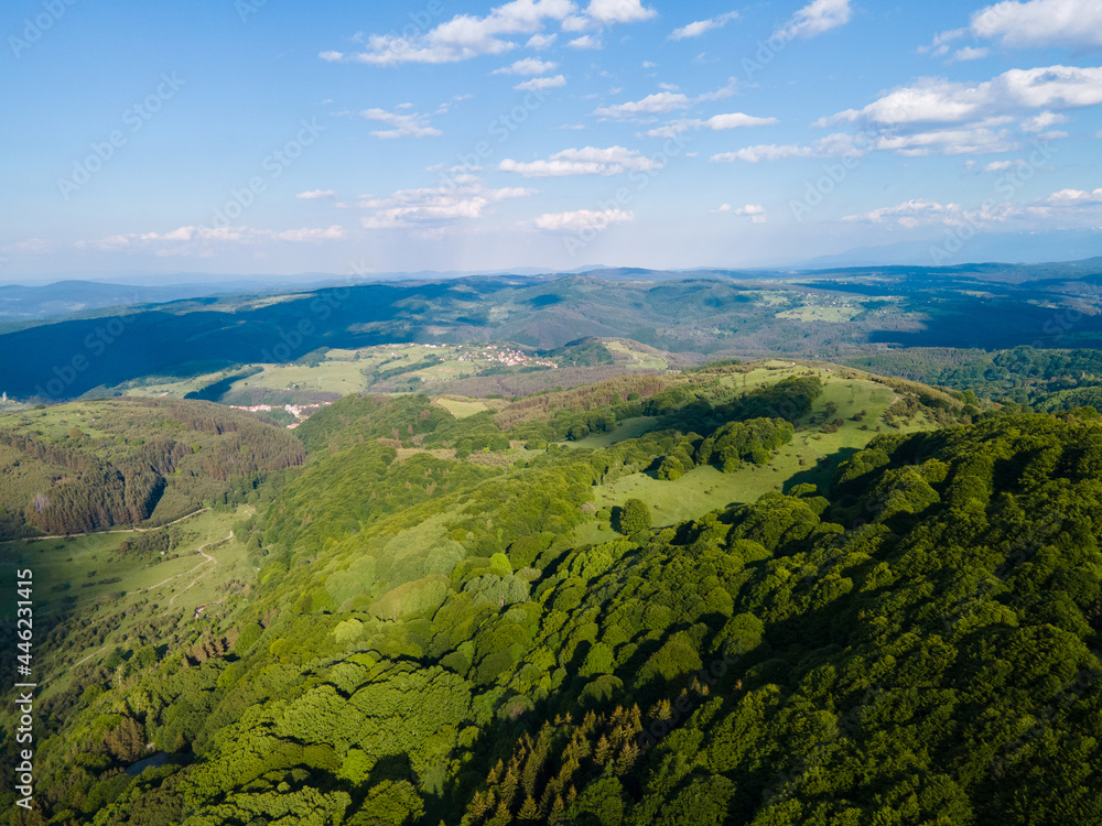 Aerial landscape with green mountains and blue sky