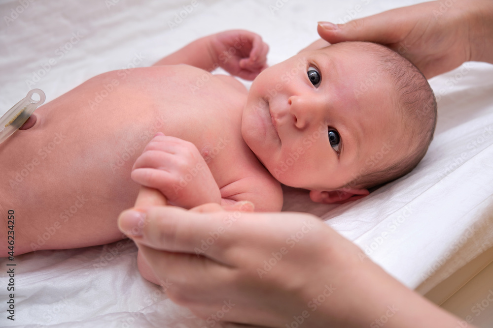 A newborn baby holds his mother finger with his hands A newborn baby holds his mother finger with his hands