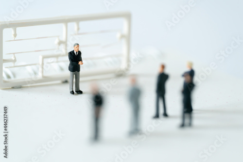 Miniature people A Businessman speech presentation on public stage on white background using as Success Business Due and New Technology products announcement partnership business development concept