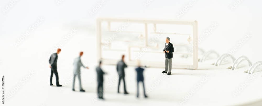 Miniature people A Businessman speech presentation on public stage on white background using as Success Business Due and New Technology product announcement partnership business development cover page Miniature people A Businessman speech presentation on public stage on white background using as Success Business Due and New Technology product announcement partnership business development cover page
