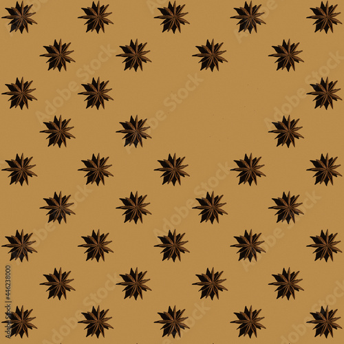 Pattern from anise stars with copy space on beige background