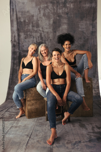 Full length shot of diverse women laughing together in a studio