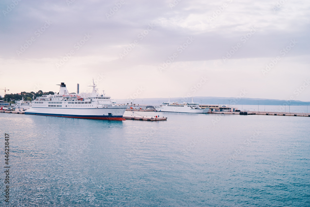 Ferryboat loading by a port pier. Concept of transportation and traveling. Ferryboat loading by a port pier. Concept of transportation and traveling.