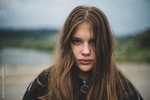 Portrait of young beautiful cute teenage girl woman with frackles and problematic skin on natural background. Girl power, body positive, real people.