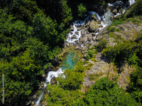 Fototapeta Naklejka Na Ścianę i Meble -  Aerial drone view of a waterfall in a river with turquoise water located in a green natural environment in Pyrenees, Spain.