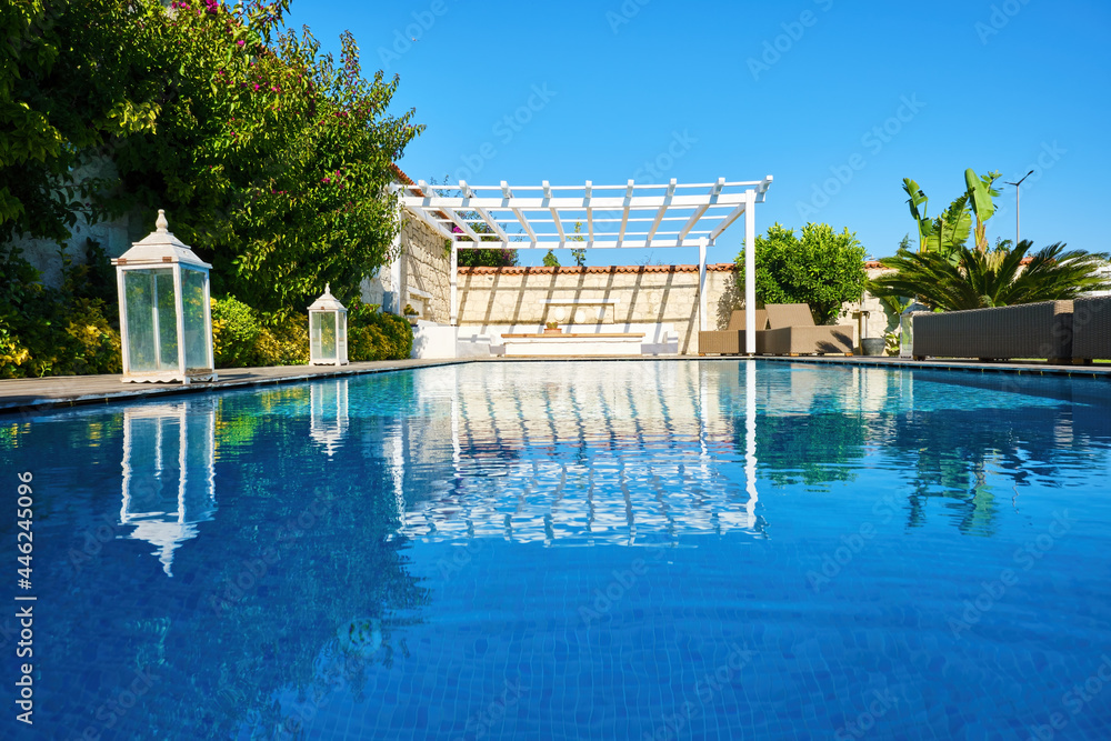 Swimming pool and patio of a residential Aegean or Mediterranean villa.