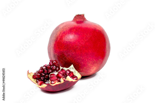 Juicy pieces of bright red cut pomegranate isolated on white background.