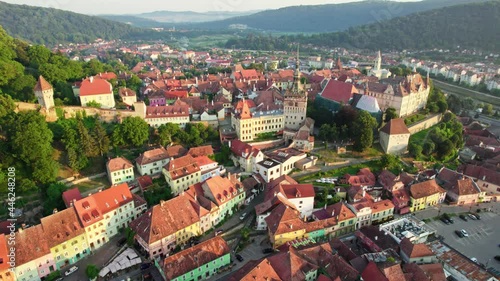 Medieval city of Sighisoara, Transylvania, Romania. Aerial view of town hall and rooftops of Sighisoara - one of the most beautiful cities in Romania. UHD, 4K
